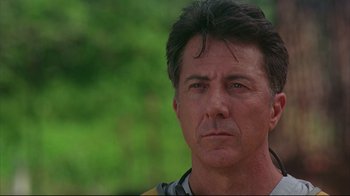 Movie still from “Outbreak” (1995), directed by Wolfgang Petersen – A man's face in front of a green background; Close Up shot, Low angle