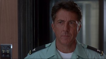Movie still from “Outbreak” (1995), directed by Wolfgang Petersen – A person wearing a uniform; Close Up shot, Over the shoulder angle