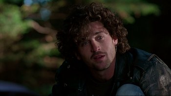 Movie still from “Outbreak” (1995), directed by Wolfgang Petersen – A person with curly hair; Close Up shot, Over the shoulder angle