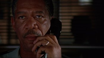Movie still from “Outbreak” (1995), directed by Wolfgang Petersen – An older man is talking on a cell phone; Close Up shot, Low angle