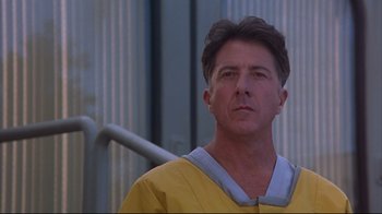 Movie still from “Outbreak” (1995), directed by Wolfgang Petersen – A person wearing a yellow shirt; Close Up shot, Low angle