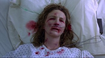 Movie still from “Outbreak” (1995), directed by Wolfgang Petersen – A woman with blood all over her face and neck; Close Up shot, Overhead angle