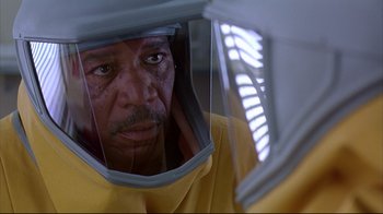 Movie still from “Outbreak” (1995), directed by Wolfgang Petersen – A person wearing a mask; Close Up shot, Over the shoulder angle