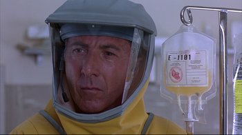 Movie still from “Outbreak” (1995), directed by Wolfgang Petersen – A man in a yellow protective suit with an infusion bottle; Close Up shot, Low angle