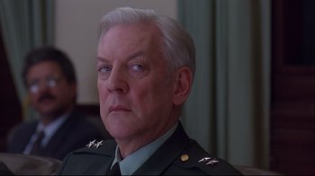 Movie still from “Outbreak” (1995), directed by Wolfgang Petersen – An older man in a military uniform looking to his left; Close Up shot, Low angle