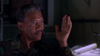 Movie still from “Outbreak” (1995), directed by Wolfgang Petersen – An older man holding his hand up in the air; Close Up shot, Low angle