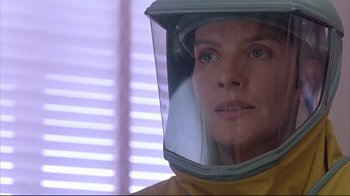 Movie still from “Outbreak” (1995), directed by Wolfgang Petersen – A woman in a yellow jacket wearing a helmet; Close Up shot, Low angle