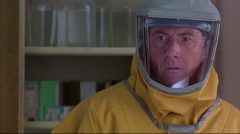 Movie still from “Outbreak” (1995), directed by Wolfgang Petersen – A man in a yellow raincoat wearing a helmet; Close Up shot, Low angle