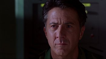 Movie still from “Outbreak” (1995), directed by Wolfgang Petersen – A man's face in the dark; Close Up shot, Low angle