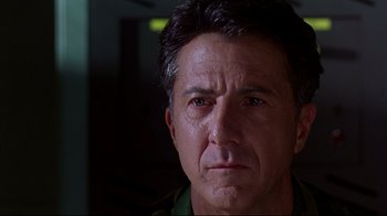 Movie still from “Outbreak” (1995), directed by Wolfgang Petersen – A man's face in a dark room; Close Up shot, Low angle