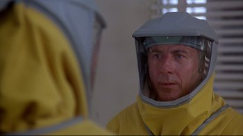 Movie still from “Outbreak” (1995), directed by Wolfgang Petersen – A man in a yellow raincoat wearing a helmet; Close Up shot, Over the shoulder angle