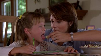 Movie still from “Outbreak” (1995), directed by Wolfgang Petersen – A woman and a child are eating food; Close Up shot, Over the shoulder angle