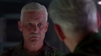 Movie still from “Outbreak” (1995), directed by Wolfgang Petersen – An older man looking at himself in the mirror; Close Up shot, Over the shoulder angle