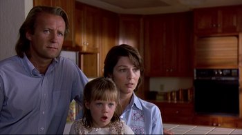 Movie still from “Outbreak” (1995), directed by Wolfgang Petersen – A woman and a man standing next to a little girl; Close Up shot, Low angle