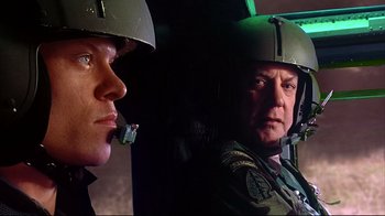 Movie still from “Outbreak” (1995), directed by Wolfgang Petersen – A man in a helmet is looking at a man in a uniform; Close Up shot, Low angle