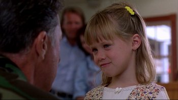 Movie still from “Outbreak” (1995), directed by Wolfgang Petersen – A little girl with a yellow bow in her hair looking at an older man; Close Up shot, Over the shoulder angle