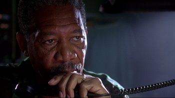 Movie still from “Outbreak” (1995), directed by Wolfgang Petersen – An older man is holding a phone in his hand; Close Up shot, Low angle