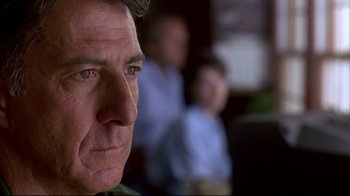 Movie still from “Outbreak” (1995), directed by Wolfgang Petersen – A person looking at the camera; Close Up shot, Over the shoulder angle