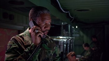Movie still from “Outbreak” (1995), directed by Wolfgang Petersen – An older man in a military uniform talking on a phone; Medium shot, Low angle