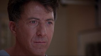 Movie still from “Outbreak” (1995), directed by Wolfgang Petersen – A man's face in a room; Close Up shot, Over the shoulder angle