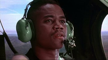 Movie still from “Outbreak” (1995), directed by Wolfgang Petersen – A man wearing a pair of green headphones; Close Up shot, Low angle