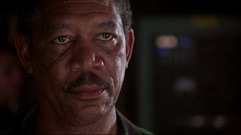 Movie still from “Outbreak” (1995), directed by Wolfgang Petersen – A person with a beard and a mustache; Close Up shot, Low angle