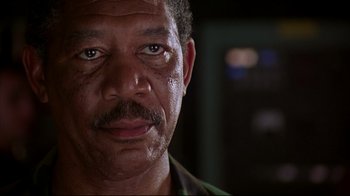 Movie still from “Outbreak” (1995), directed by Wolfgang Petersen – A person with a beard and a mustache; Close Up shot, Low angle