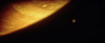 Movie still from “Outland” (1981), directed by Peter Hyams – The moon is glowing in the night sky; Extreme Wide shot, Overhead angle