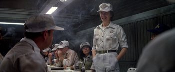 Movie still from “Outland” (1981), directed by Peter Hyams – A group of people sitting around a table; Medium shot, Over the shoulder angle