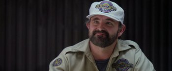 Movie still from “Outland” (1981), directed by Peter Hyams – A man with a beard wearing a white hat; Close Up shot, Over the shoulder angle