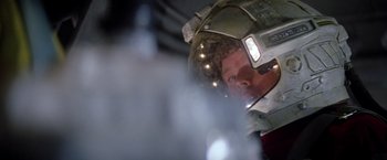Movie still from “Outland” (1981), directed by Peter Hyams – A man wearing a space suit and a helmet; Close Up shot, Low angle