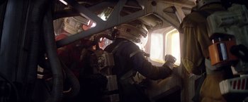 Movie still from “Outland” (1981), directed by Peter Hyams – A person in a space suit inside of an airplane; Medium shot, Low angle