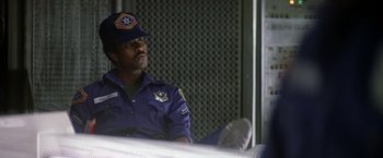 Movie still from “Outland” (1981), directed by Peter Hyams – A police officer sitting in front of a window; Medium shot, Low angle