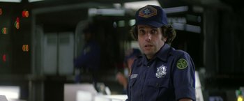 Movie still from “Outland” (1981), directed by Peter Hyams – A man in a police uniform is looking at the camera; Close Up shot, Low angle