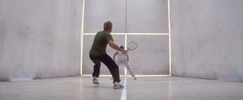 Movie still from “Outland” (1981), directed by Peter Hyams – Two people playing tennis in a gym; Wide shot, Low angle