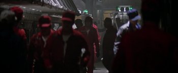 Movie still from “Outland” (1981), directed by Peter Hyams – A group of people walking down a street at night; Wide shot, Low angle