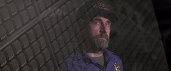 Movie still from “Outland” (1981), directed by Peter Hyams – A man with a beard and a police uniform; Close Up shot, Over the shoulder angle