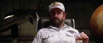 Movie still from “Outland” (1981), directed by Peter Hyams – A man in a white shirt wearing a white hat; Close Up shot, Low angle