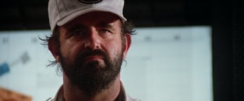 Movie still from “Outland” (1981), directed by Peter Hyams – A person with a beard wearing a hat; Close Up shot, Low angle