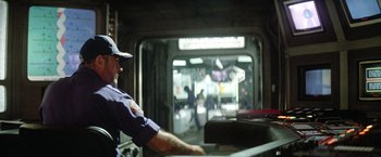 Movie still from “Outland” (1981), directed by Peter Hyams – A man standing in front of an entrance to a train station; Medium shot, Low angle