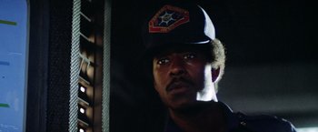 Movie still from “Outland” (1981), directed by Peter Hyams – A person wearing a hat; Close Up shot, Low angle