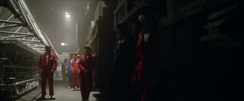 Movie still from “Outland” (1981), directed by Peter Hyams – A group of people walking down a street at night; Wide shot, Low angle