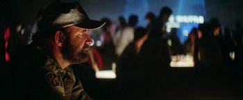 Movie still from “Outland” (1981), directed by Peter Hyams – A man with a beard wearing a baseball cap; Close Up shot, Over the shoulder angle