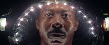 Movie still from “Outland” (1981), directed by Peter Hyams – A person wearing a crown; Close Up shot, High angle