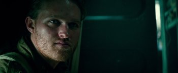 Movie still from “Overlord” (2018), directed by Julius Avery – A person with a beard looking at the camera; Close Up shot, Low angle