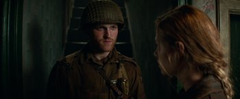 Movie still from “Overlord” (2018), directed by Julius Avery – A man in a military uniform talking to a woman; Close Up shot, Over the shoulder angle