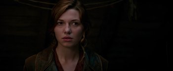 Movie still from “Overlord” (2018), directed by Julius Avery – A young woman is looking into the camera; Close Up shot, Over the shoulder angle