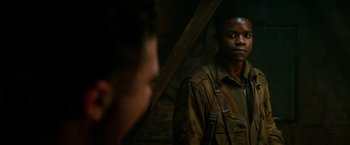 Movie still from “Overlord” (2018), directed by Julius Avery – A man standing in front of a mirror looking at himself in the mirror; Close Up shot, Over the shoulder angle