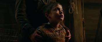 Movie still from “Overlord” (2018), directed by Julius Avery – A young boy looking up into the sky while being held by his father; Close Up shot, Low angle