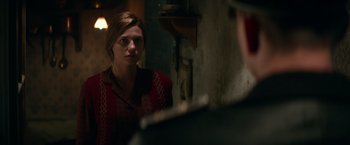 Movie still from “Overlord” (2018), directed by Julius Avery – A woman looking at a man in the mirror; Medium shot, Over the shoulder angle